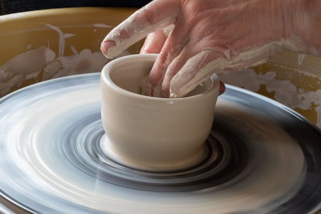 Santa Barbara artisan making a ceramic bowl on a potters wheel